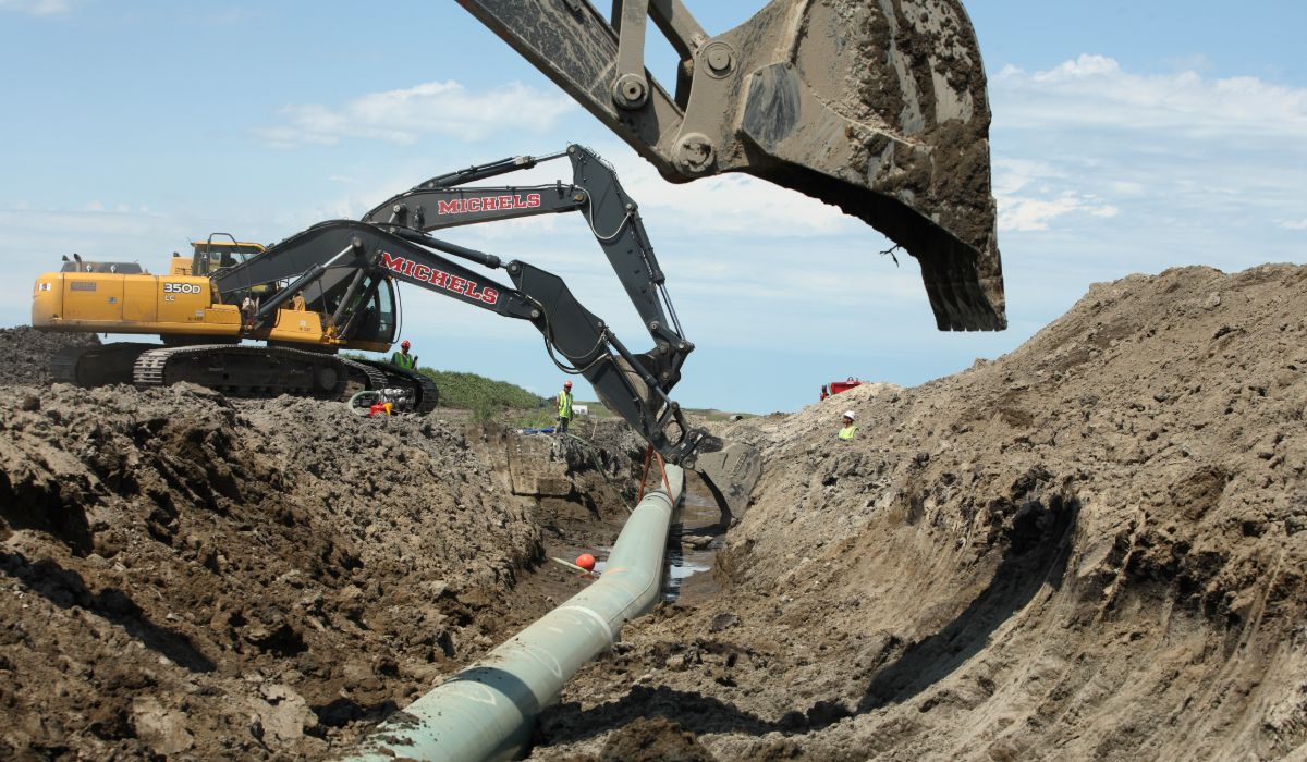 A pipeline being worked on in the dirt.