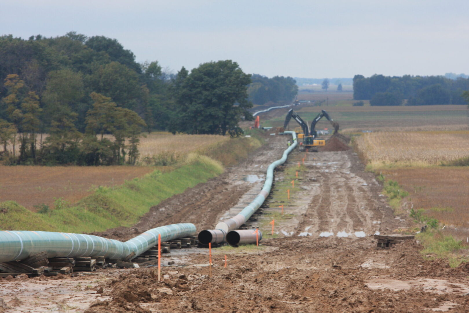 A pipeline is being worked on in the dirt.