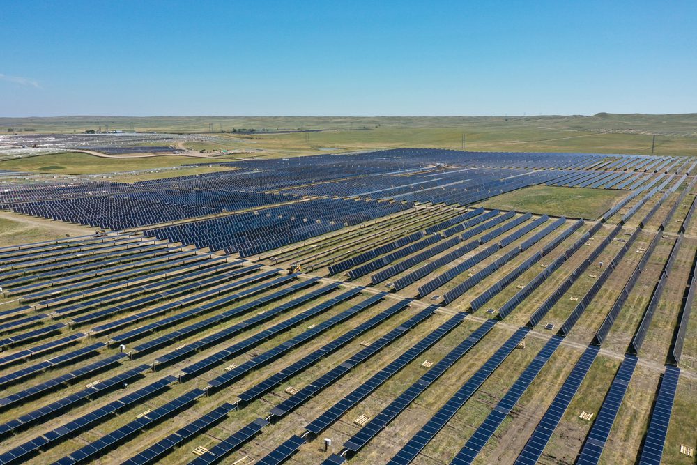 A large field of solar panels in the middle of nowhere.